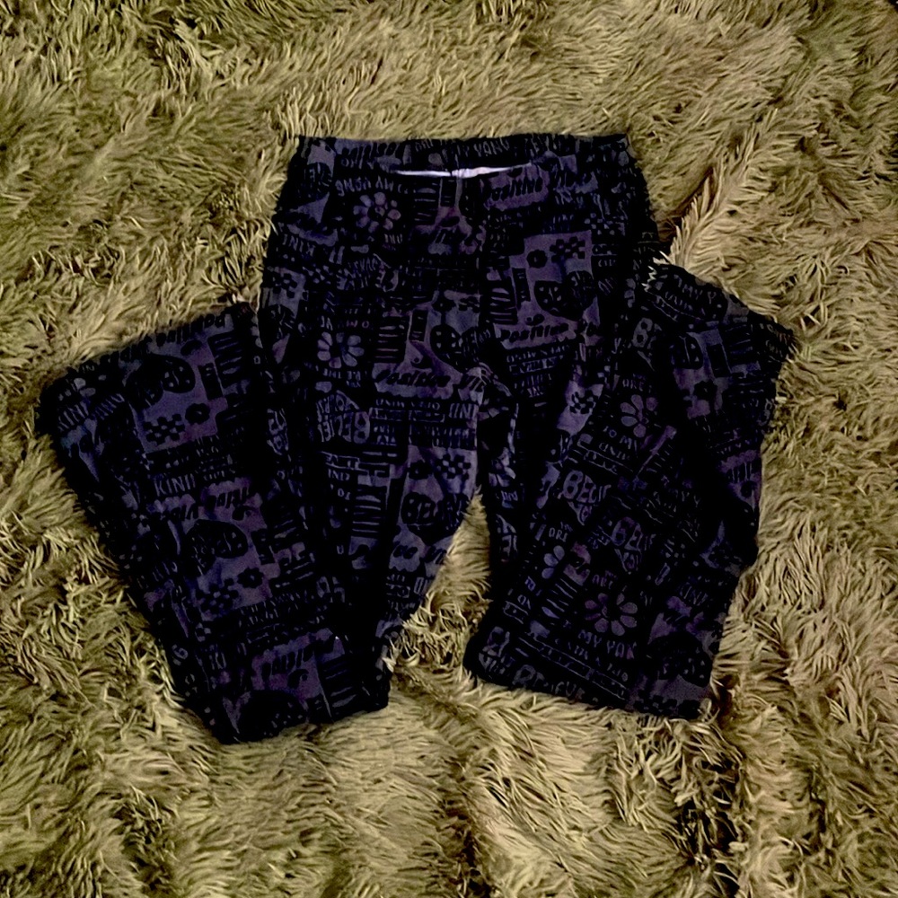 Black pants with writing and symbols on it
